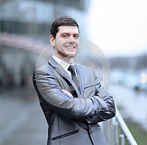 Successful businessman standing on the balcony of the office