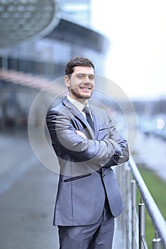 Successful businessman standing on the balcony of the office