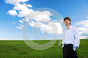 Successful businessman standing on grassland