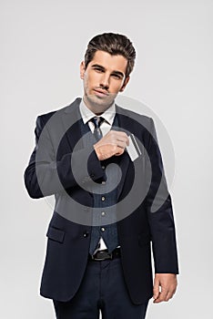 successful businessman in suit putting credit