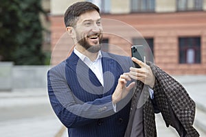 Successful businessman takes photos on a mobile phone