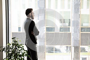 Successful businessman thinking looking in distance in office