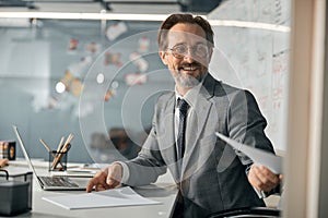 Successful businessman is wearing suit at work