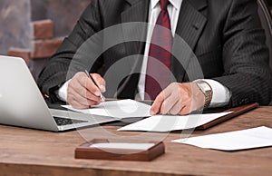 Successful businessman working with documents in office, close up