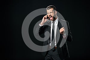 successful businessman yelling while talking on smartphone,