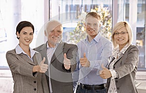 Successful businessteam giving thumbs up