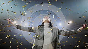 Successful businesswoman with arms up celebrating his victory. View of excited young businesswoman keeping arms raised