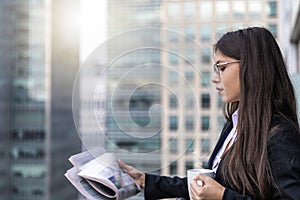 Successful businesswoman in front of modern office buildings in the city