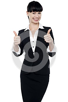 Successful businesswoman gesturing thumbs up