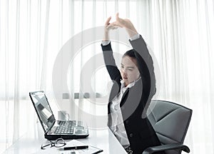 Successful businesswoman relaxing in her chair at the office