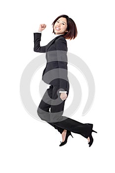 Successful businesswoman in suit jumping joyful