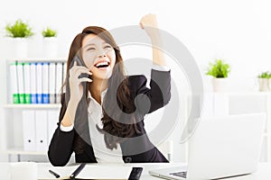 Successful businesswoman talking on the phone in office