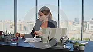 Successful businesswoman working desk in panoramic office. Tired woman finish