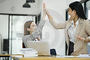 Successful Businesswomen Celebrating with a High Five..