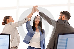 Successful businesswomen motivate each other with High Five