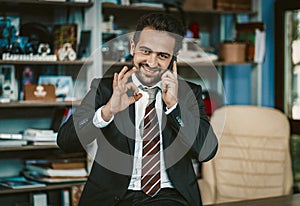 Successful Busy Business Man Shows Ok Using Phone