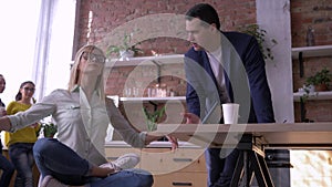 Successful calm businesswoman relaxing and meditating at workplace sitting in yoga pose with eyes closed and not