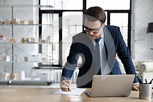 Successful Caucasian businessman busy working on laptop