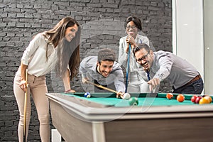 Successful cheerful business people playing snooker