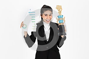 Successful cheerful young Asian business woman celebrating with trophy award over white isolated background. Success achievement