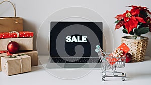 Successful Christmas Season in E-Commerce, Christmas online shopping. Open laptop computer Display screen, mini shopping