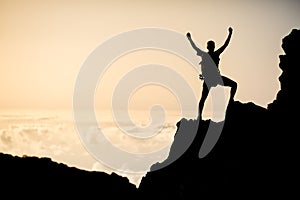 Successful climbing or hiking, inspiring silhouette in mountains photo