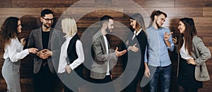 Successful company with happy workers standing in row in modern office