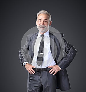 Successful, confident businessman holding his hands at belt.