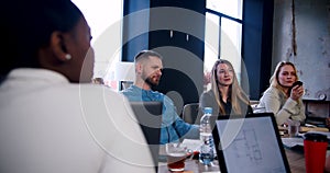 Successful confident Caucasian business people sit and listen at loft healthy office workplace meeting slow motion.