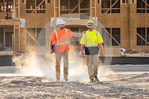 Successful construction site workers with builders equipment. Construction site workers in a helmet working on a