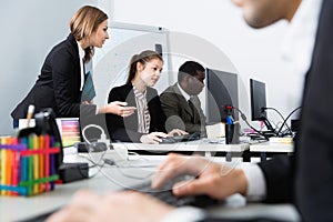 Successful coworkers engaged in business activities in busy open plan office