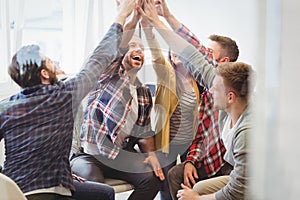 Successful creative business people giving high-five