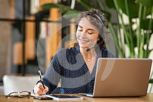 Successful customer service representative using laptop at office