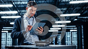 Successful Data Center IT Specialist Using Tablet Computer. Server Farm Cloud Computing Facility