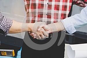 Successful deal, Female architect shaking hands with client.