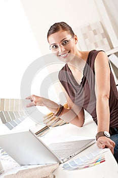 Successful designer woman at office with laptop