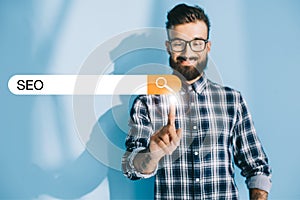 successful developer in checkered shirt pointing at SEO