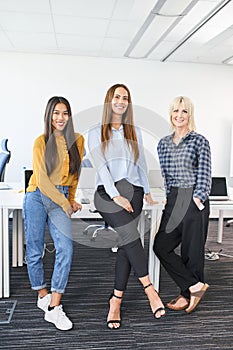 Successful diverse female business team standing together at startup office