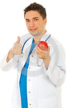 Successful doctor holding apple