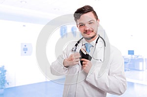 Successful doctor placing money in his pocket