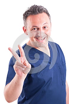 Successful doctor showing victory sign