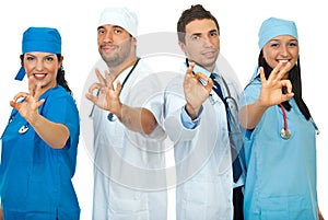 Successful doctors team showing okay sign photo