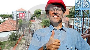 Successful Engineer With Red Hardhat Showing Thumbs up at Construction Site