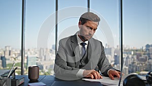 Successful executive signing deal in modern office. Pensive professional plan