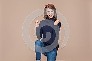 Successful expressive woman rejoicing her victory