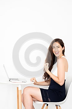 Successful and extremely happy young Caucasian business woman with achievement excited and won victory sitting with laptop.