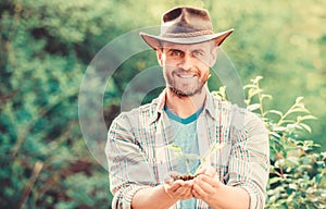 Successful farmer hold plant in ground in hands. Eco farm worker. Earth day. happy earth day. Eco living. farming and