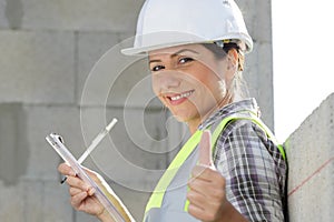 successful female architect shows thumb up