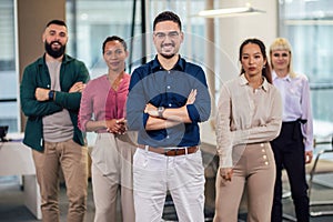 Successful group of business people at modern office looking at camera
