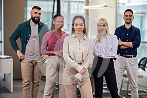 Successful group of business people at modern office looking at camera